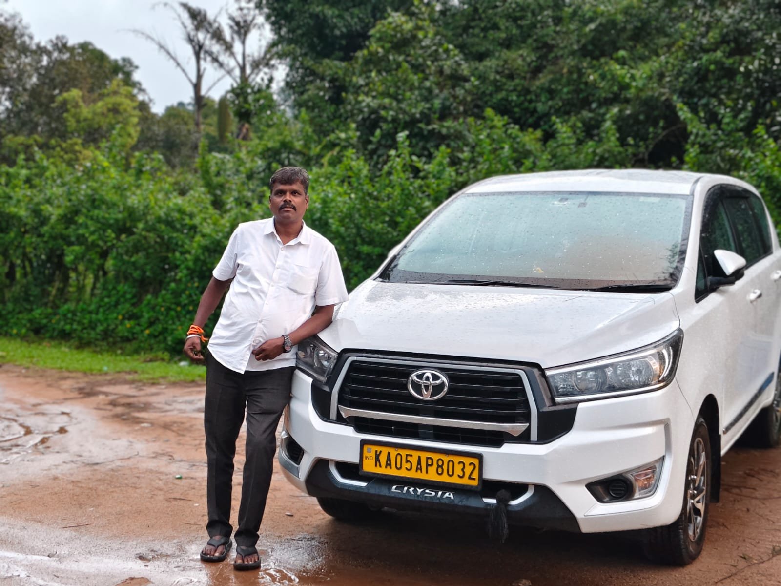 Founder of Sri Venkateshwara Tours and Travels with vehicle
